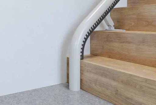 Standard drop nose rail ending on an Access Flow X, at the foot of a wooden staircase