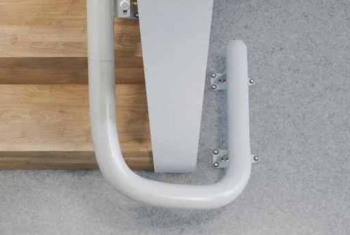 Horizontal overrun rail ending on an Access Flow X, at the foot of a wooden staircase