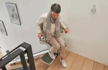 Seated at the bottom landing, feet on the folding footrest, before setting off.