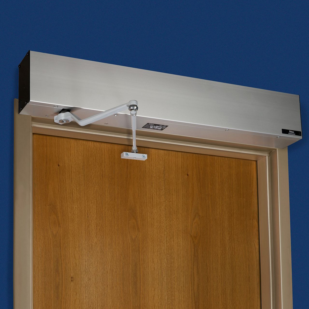 Automatic door opener mounted above an interior door