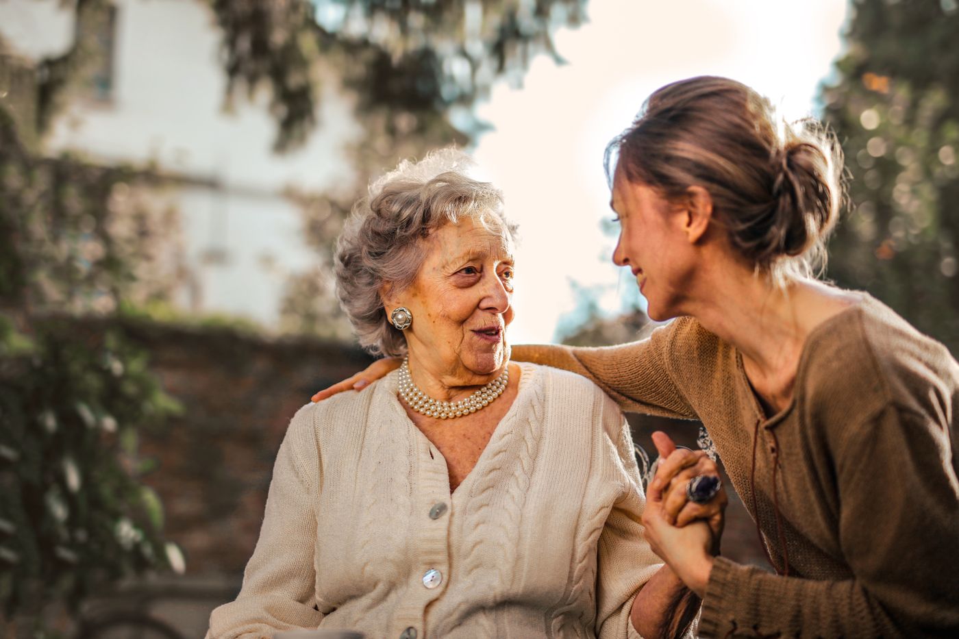 Two older adults talking together at home