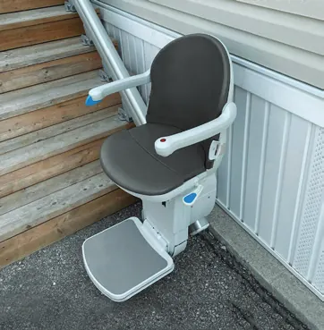 Handicare 1000 outdoor stairlift in Slate grey beside exterior steps and a metal handrail