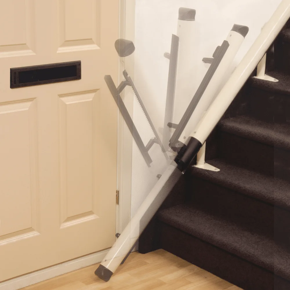 Powered hinge section of a stairlift rail folding upward away from a doorway at the bottom of a staircase
