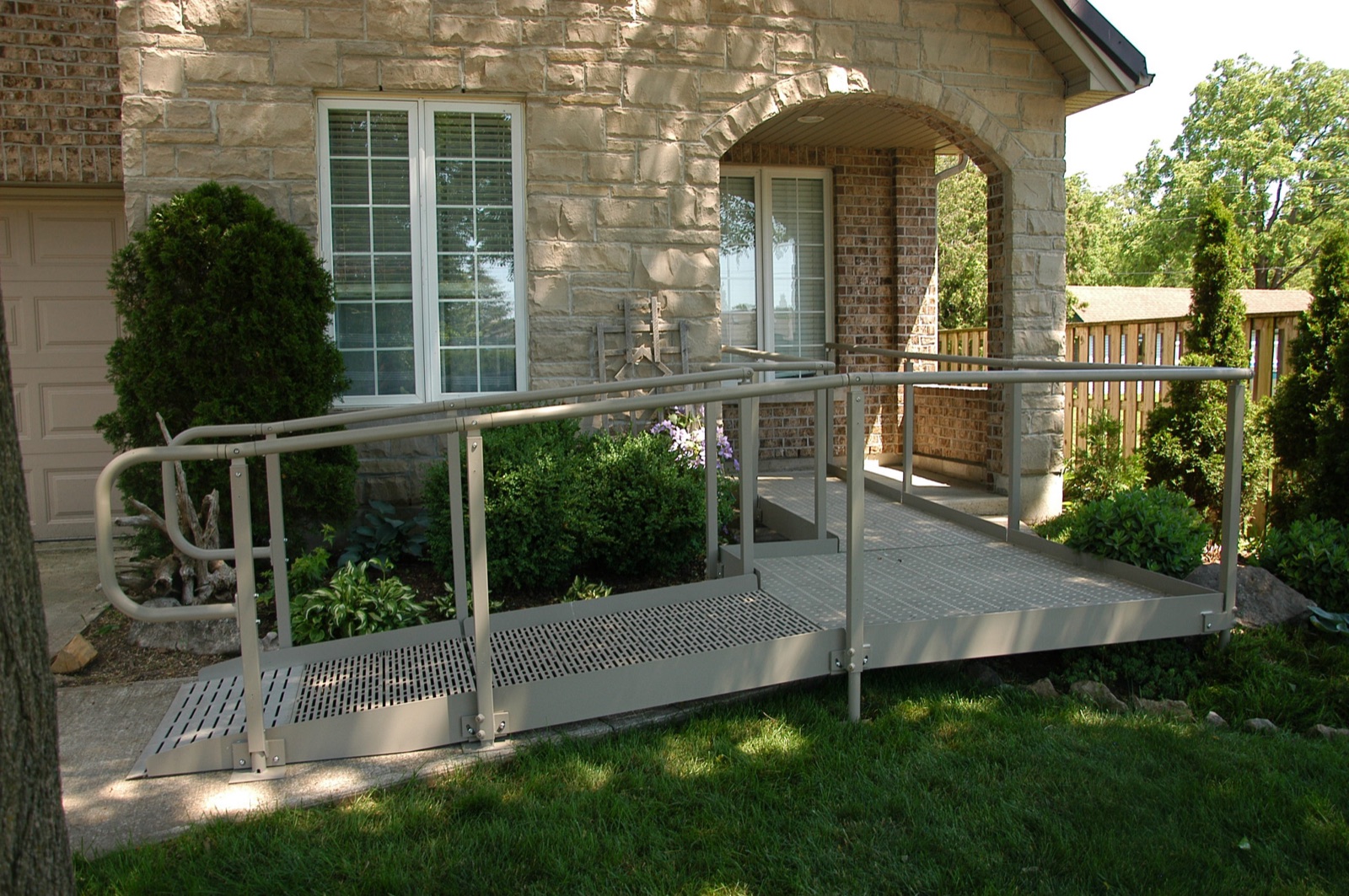 A modular metal ramp installed at a house entrance