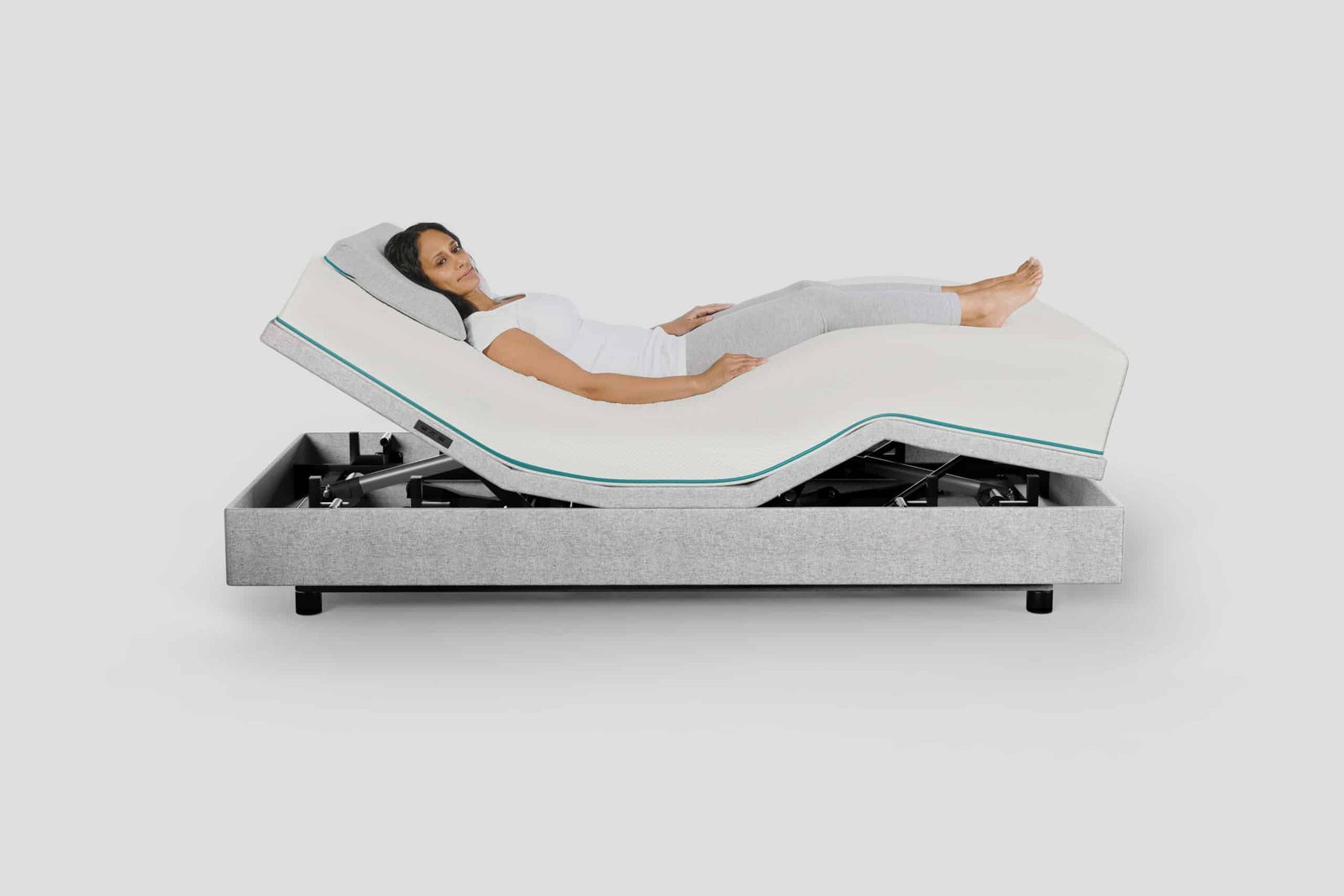 The Orthex Sophia 3 hi-low homecare bed raised at the head and knees, with a woman resting on it