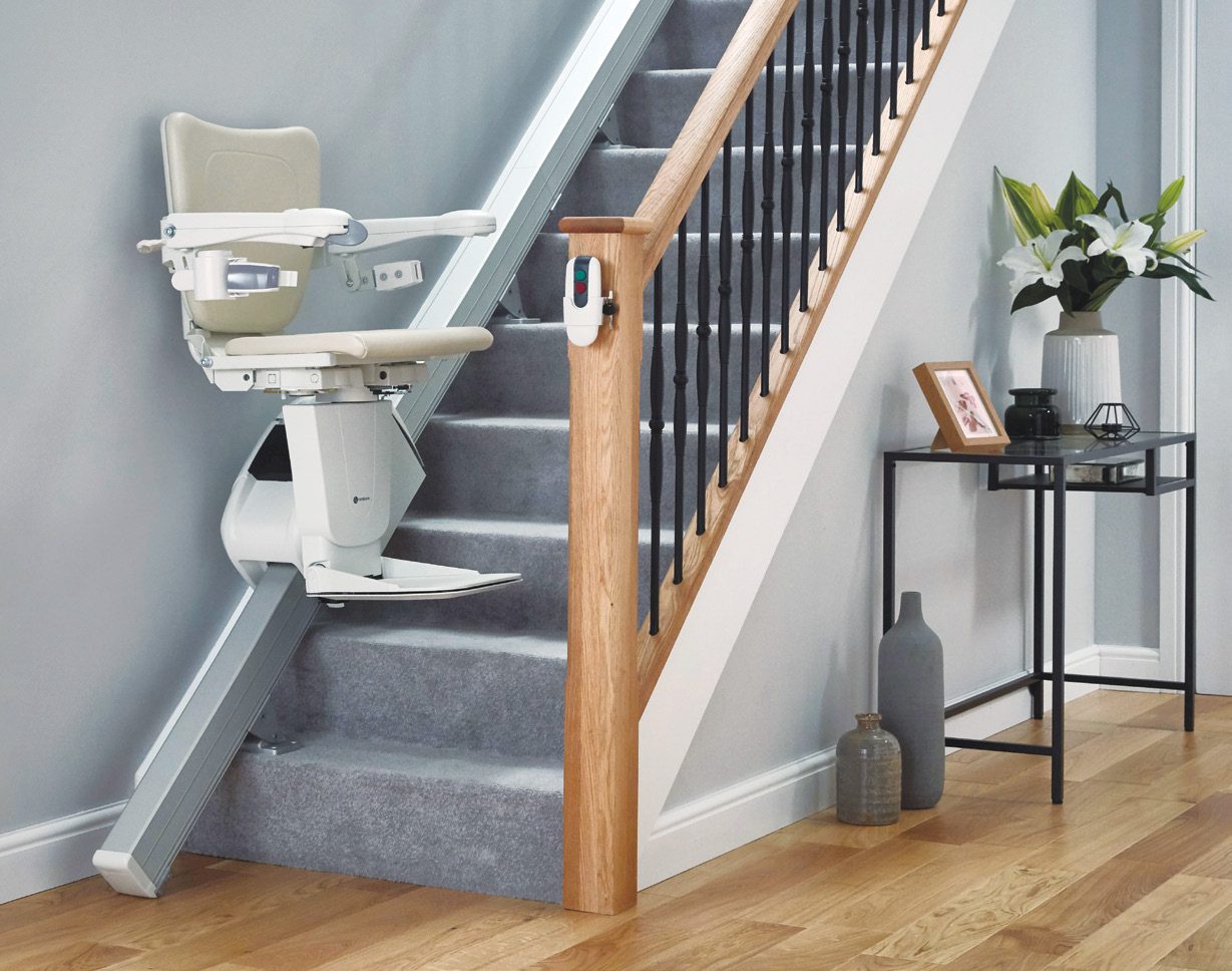 Handicare 1100 straight stairlift parked at the bottom of a staircase